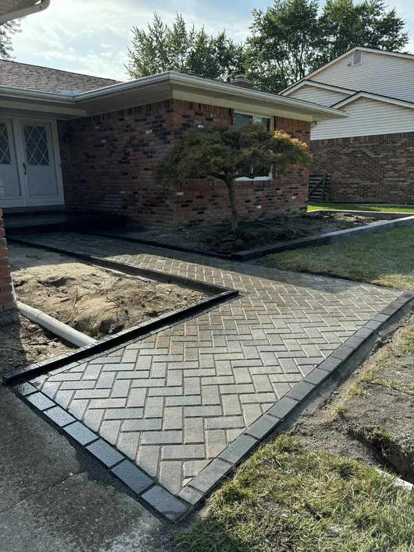 Herringbone brick paver driveway with Japanese maple