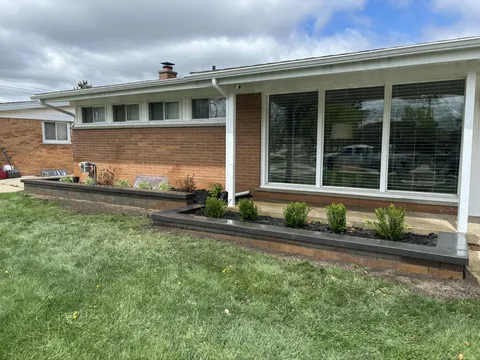 Fresh landscape installation with new retaining wall and plantings